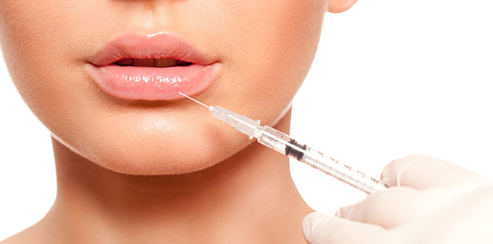 closeup beautiful woman face, syringe injection to lips beauty concept